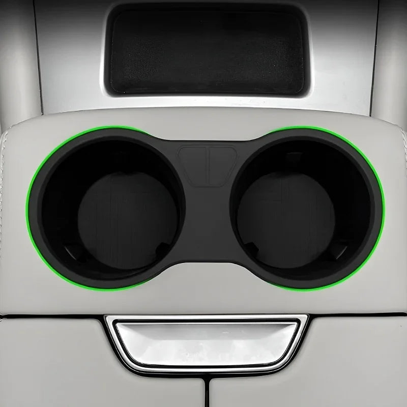 Black silicone cup holder mats with lime green edges for car center console.