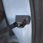 Black durable plastic door edge protector installed on a light blue car body.