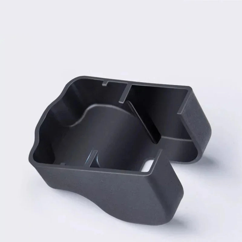 Matte black textured plastic interior storage organizer tray for car console.