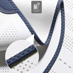 Close-up of premium white perforated leather with navy blue braided edge stitching.