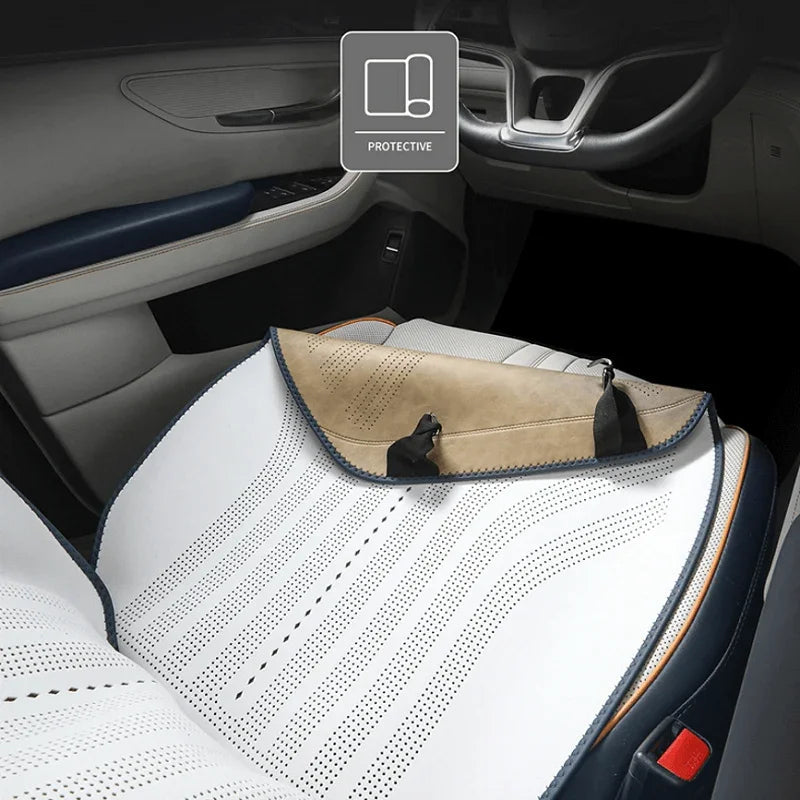 Perforated white and tan leather car seat cover for premium interior protection.