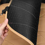 Black textured waterproof car floor mat with tan leather trim and durable stitching.