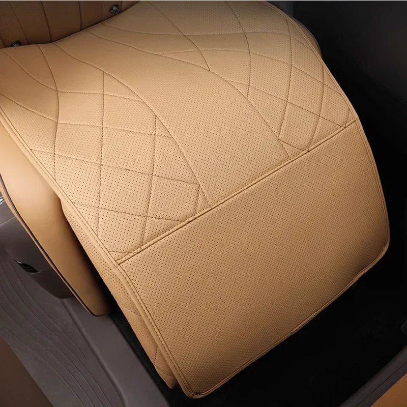 Tan perforated leather car seat cover with diamond stitching pattern.