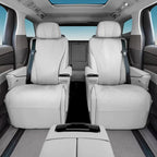 Luxury white leather rear car seats with diamond stitching and matching armrests.