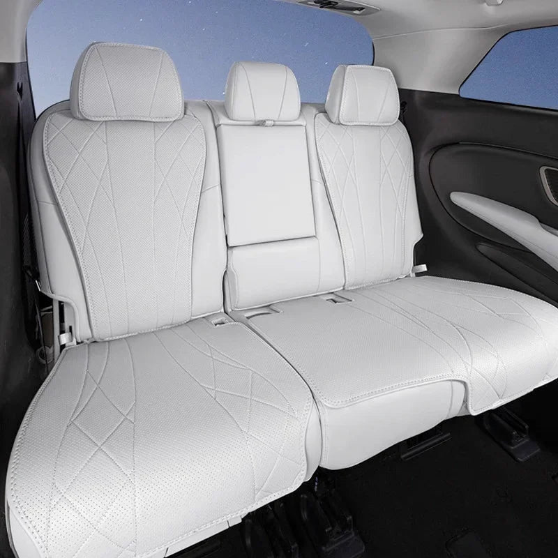 Custom white perforated leather car seat covers with diamond stitching for rear seats.