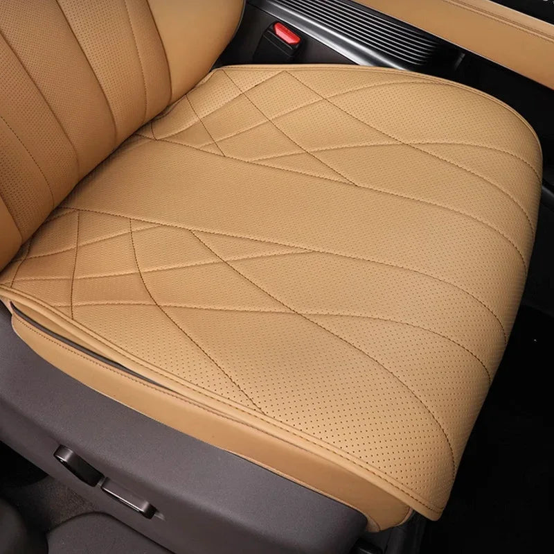 Tan perforated leather car seat cover with premium diamond quilted stitching.
