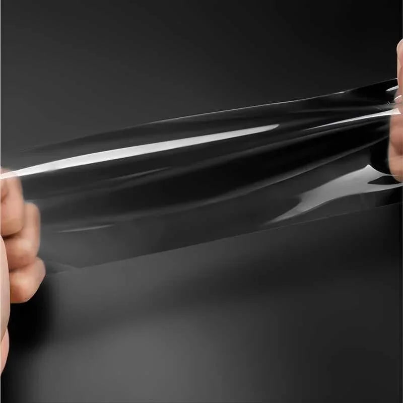 Transparent protective film being stretched, showcasing its flexible and durable material.