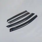 Set of four glossy black acrylic car window rain guards and wind deflectors.