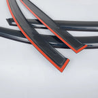 Glossy black car window weatherstrips with a vibrant red accent trim.