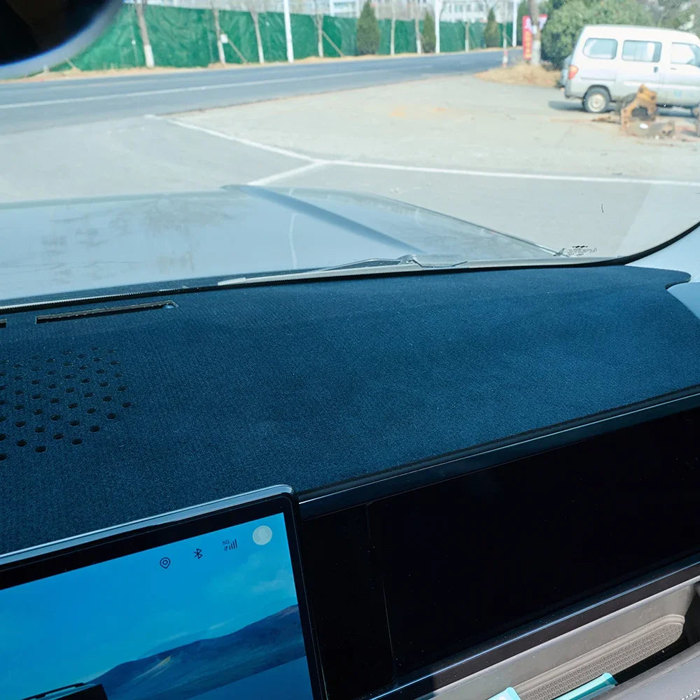 Professional black suede anti-glare dashboard cover for a car interior.