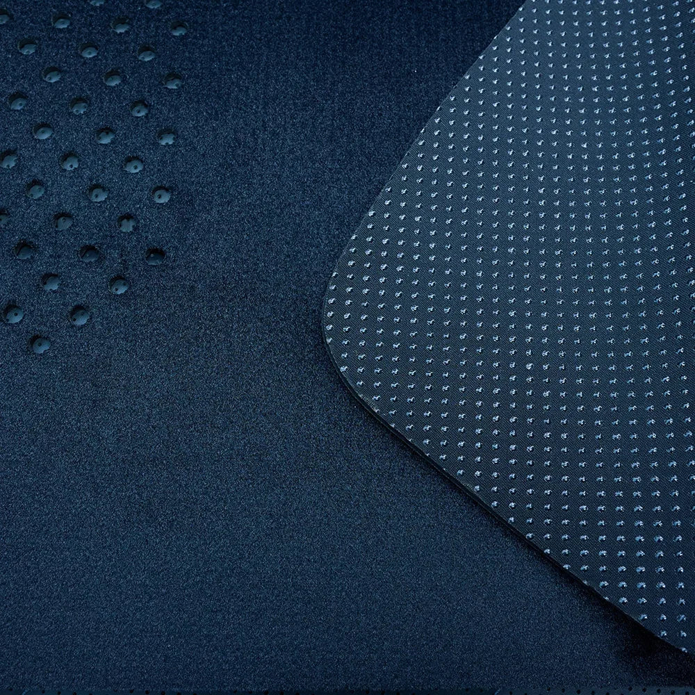 Close-up of navy blue car floor mat material featuring a durable anti-slip textured surface.