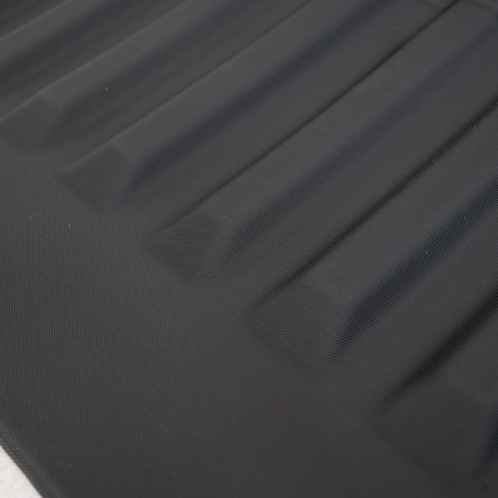 Close-up of a black textured waterproof car mat featuring durable anti-slip ridges.
