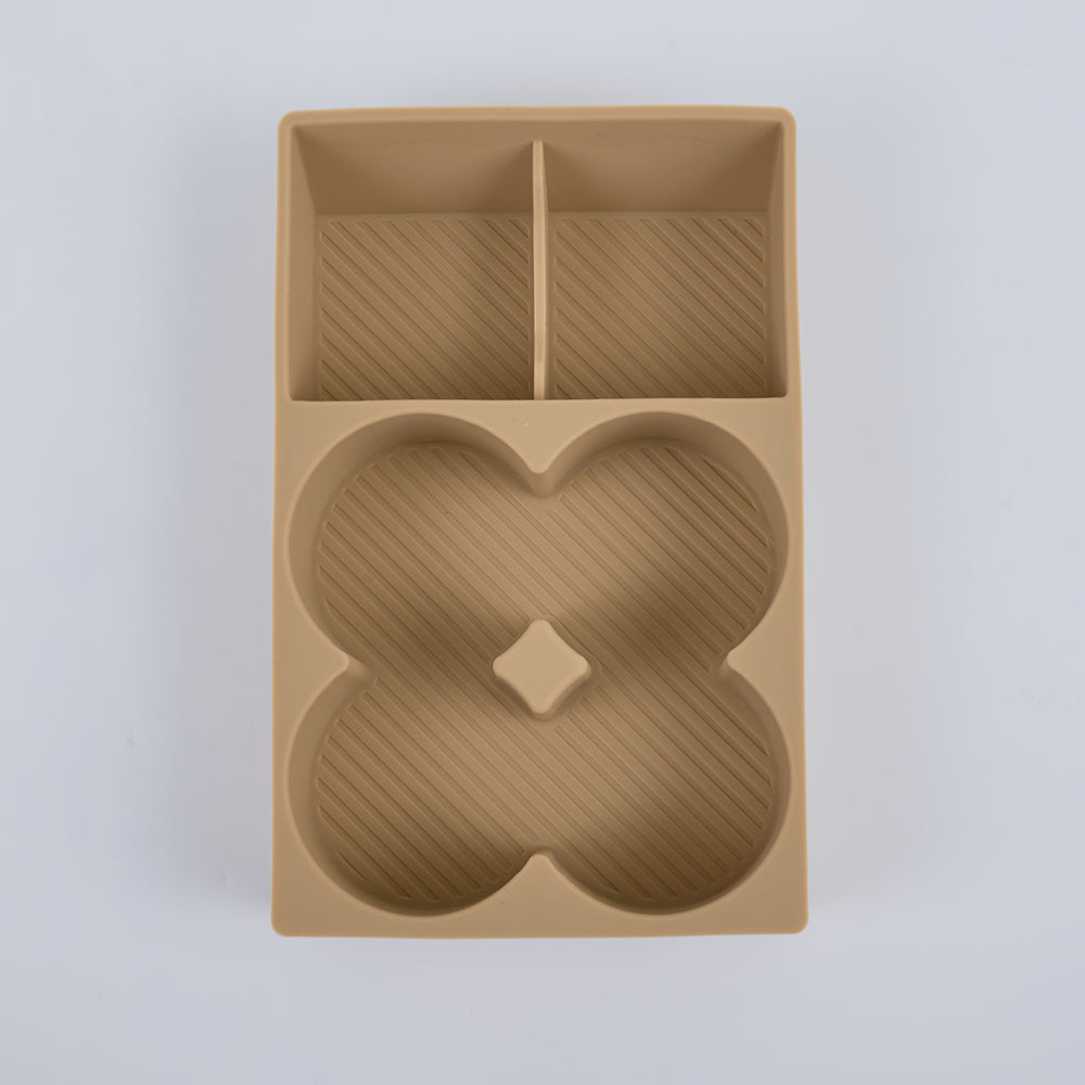 Tan TPE car center console organizer with unique clover-shaped compartment and ribbed texture.