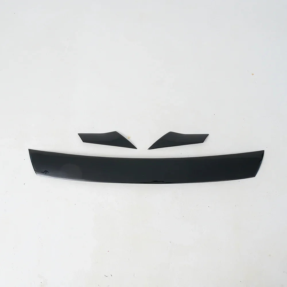 Glossy black aerodynamic car spoiler kit made of durable composite material.