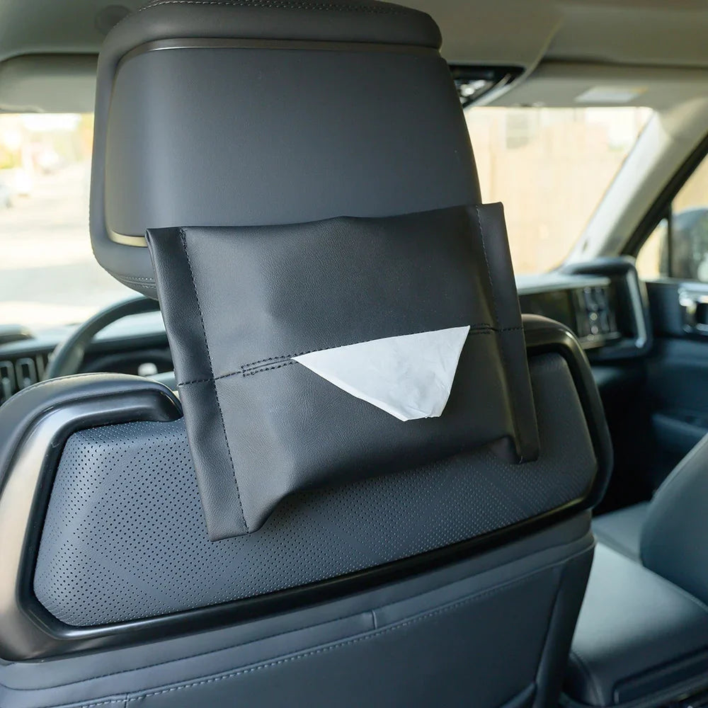Black premium faux leather headrest tissue box holder for car interior.