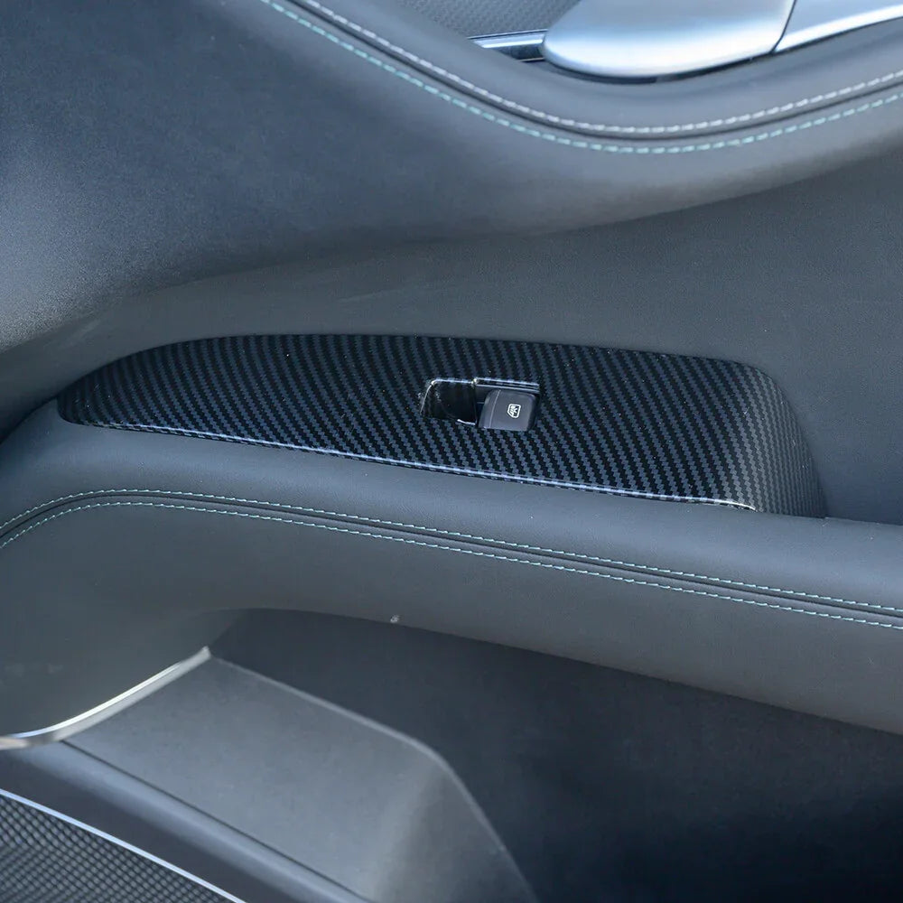 Black carbon fiber interior door trim panel with precise stitching and lock switch.