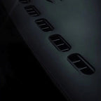 Black premium leather car seat with integrated ventilation holes for breathability.