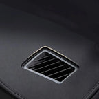Black leather interior with a sleek silver-rimmed rectangular air vent.