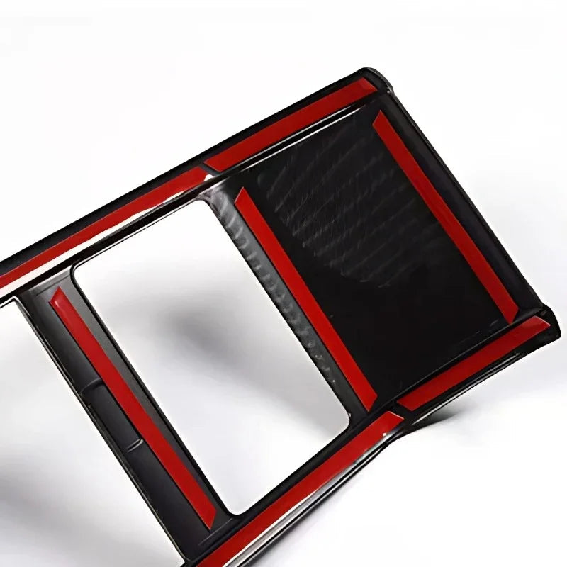 Black carbon fiber texture interior trim with striking red accent borders.