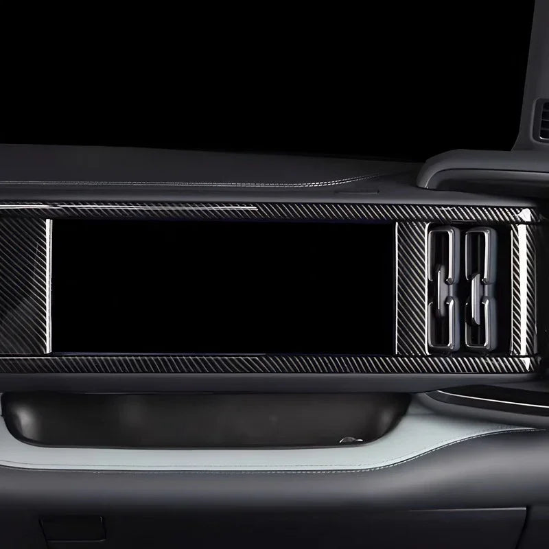 Black carbon fiber trim panel for BYD dashboard featuring a sleek textured finish.