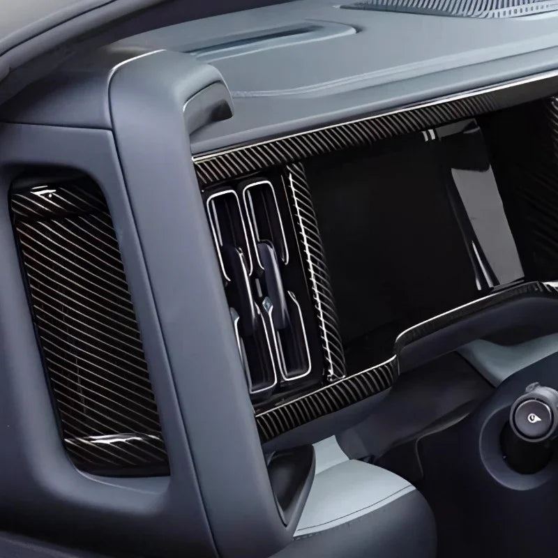 Black carbon fiber trim kit for BYD dashboard featuring a sleek, glossy texture.