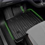 Black heavy-duty rubber car floor mat with textured pattern and green LED accent lighting.