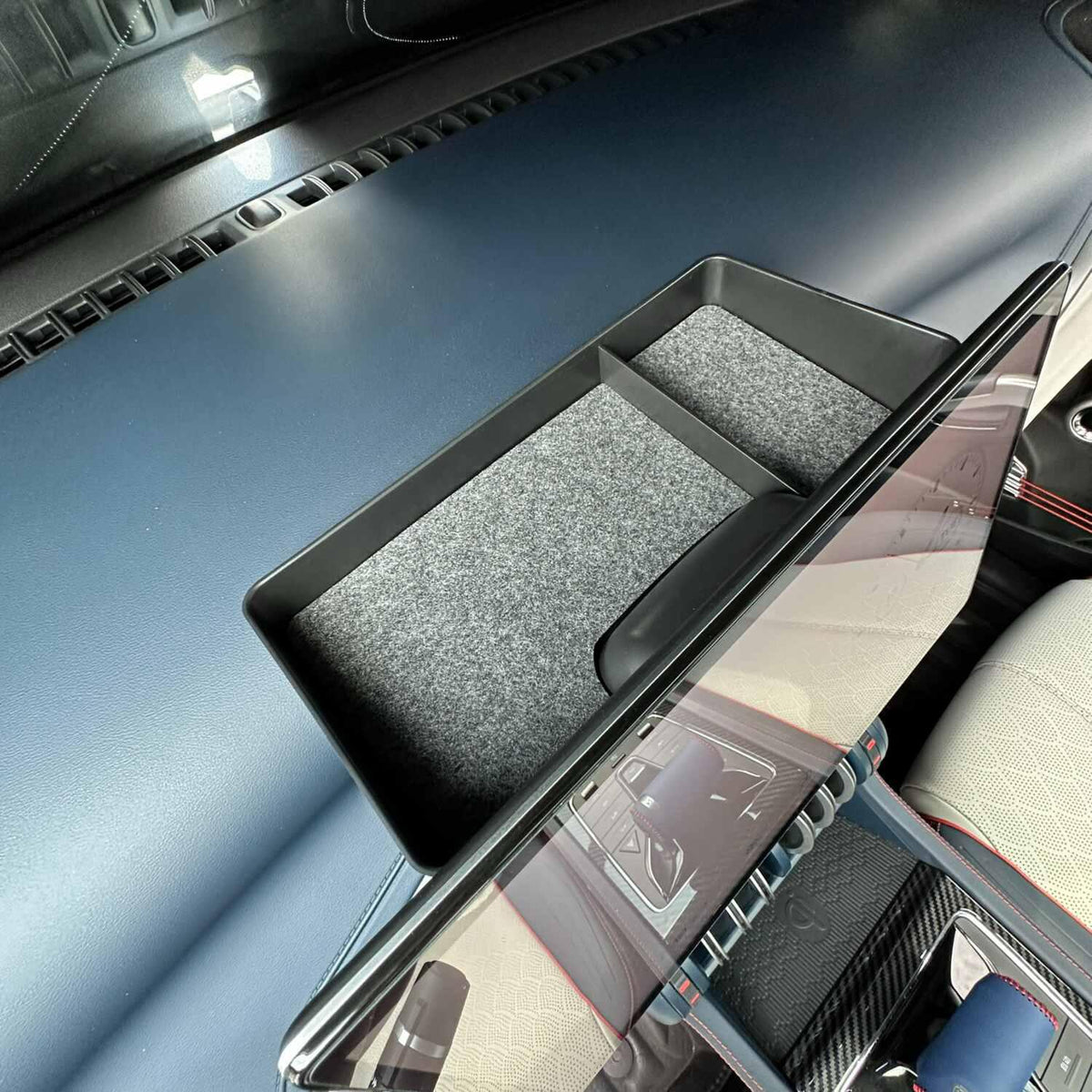 Black felt-lined center console organizer tray installed in a BYD vehicle interior.