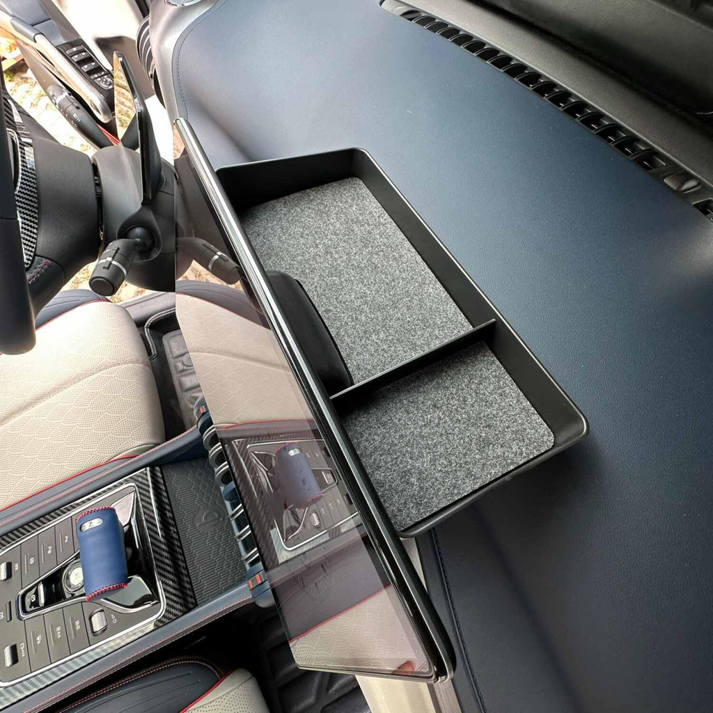 Black matte plastic car dashboard organizer tray with grey felt lining for BYD interior.