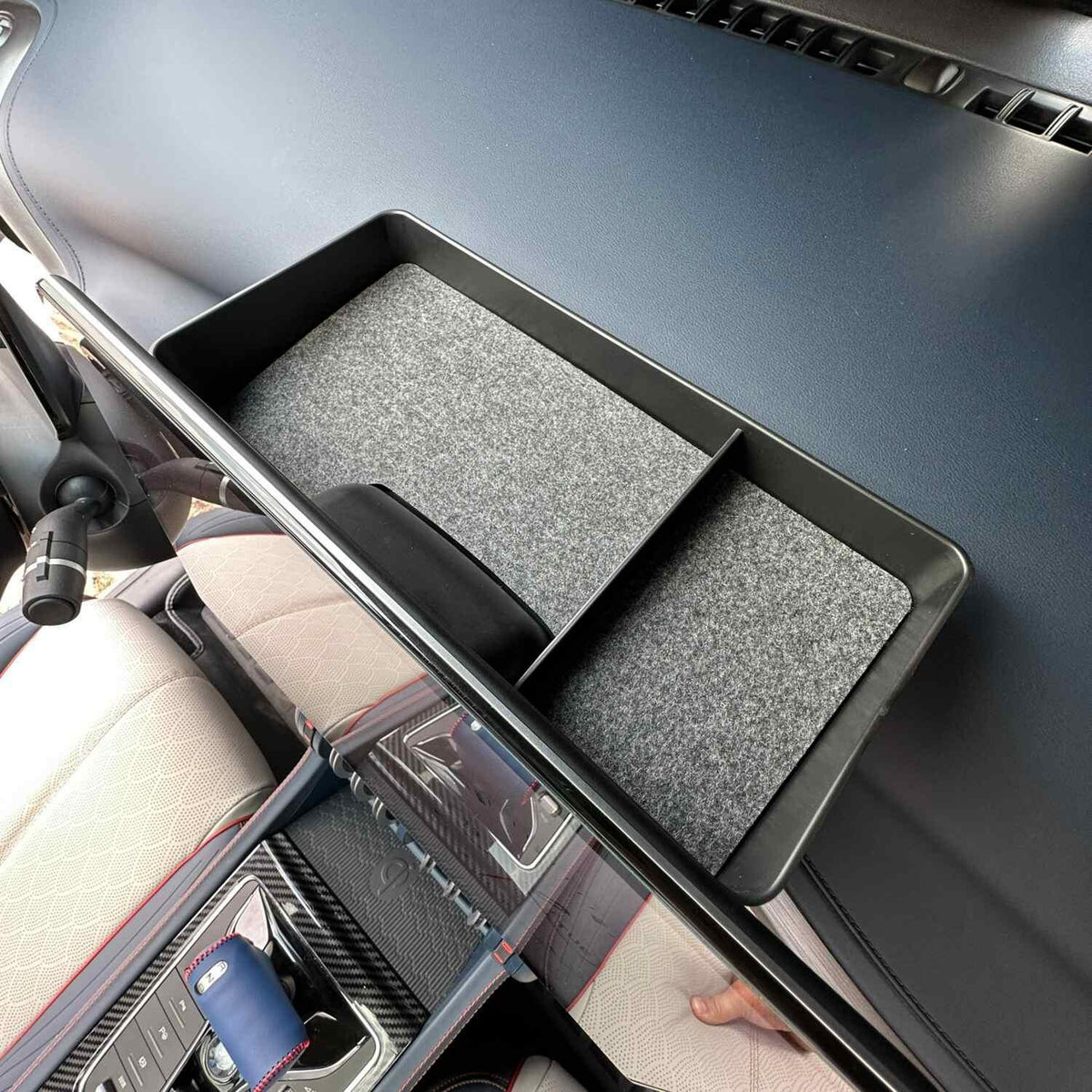 Black dual-compartment center console organizer tray with grey felt lining for BYD interior.