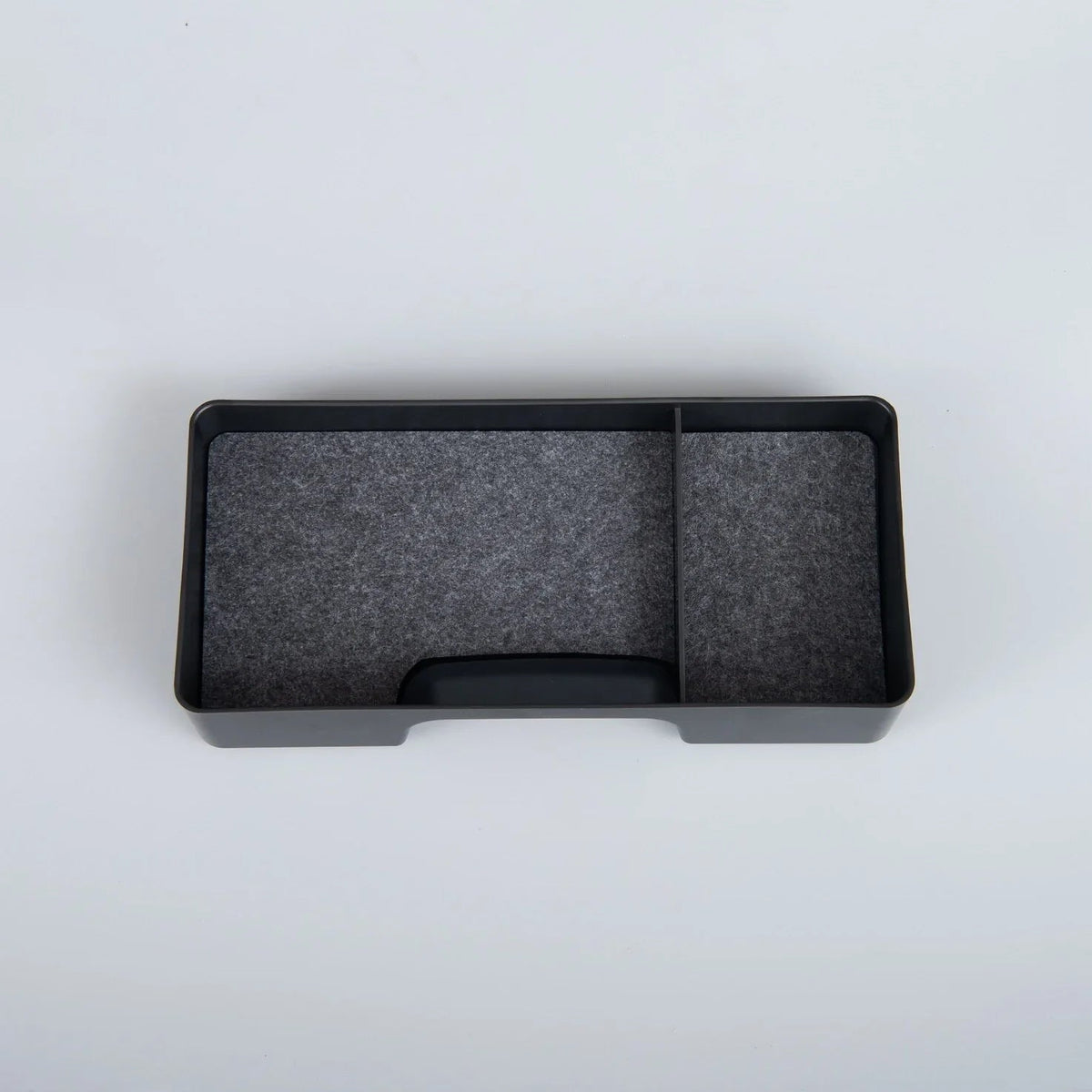 Black dual-compartment car center console organizer tray made of durable matte material.