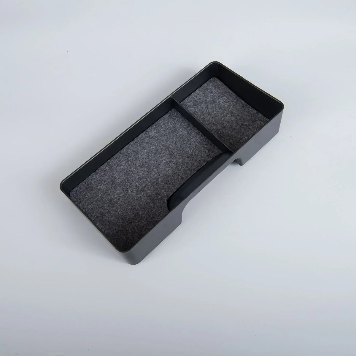 Black rectangular organizer tray with a grey felt lining for car interior storage.