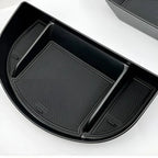 Black durable plastic car organizer tray with three compartments and anti-slip textured lining.