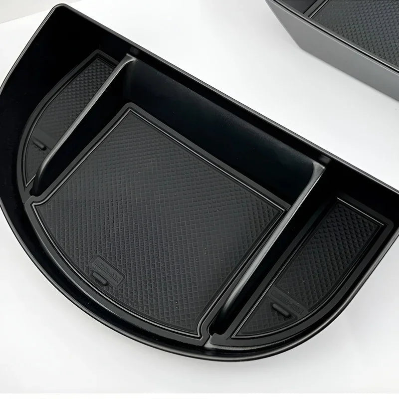 Black durable plastic car organizer tray with three compartments and anti-slip textured lining.