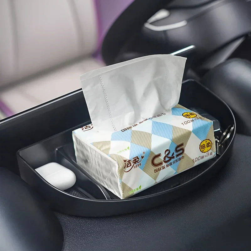 White and blue C&S tissue box in a black plastic car center console organizer.