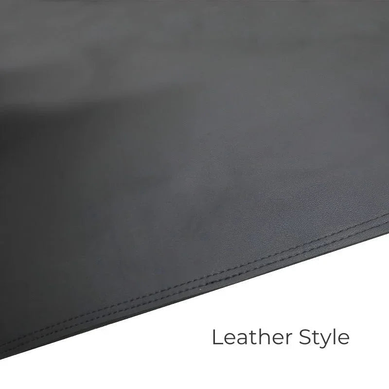 Close-up of high-quality black leather-style car interior upholstery with precise stitching.