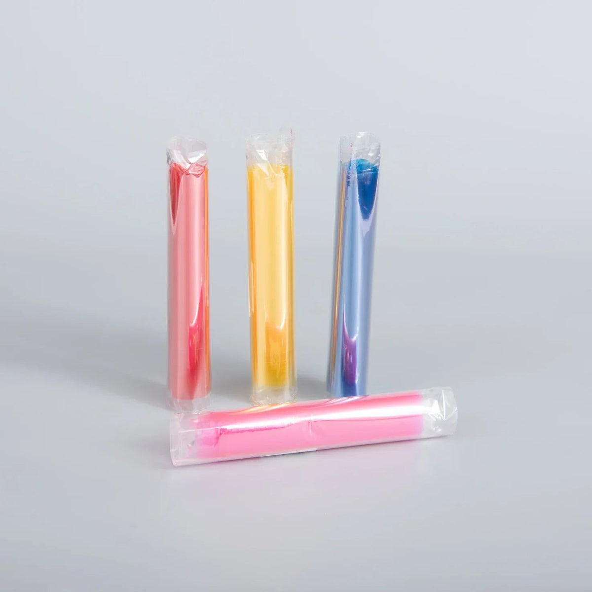 Three colorful slim-fit protective sleeves in pink, yellow, and blue, individually wrapped in clear plastic.