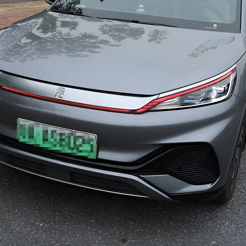Close-up view of the sleek grey front bumper and headlight of a BYD electric vehicle.