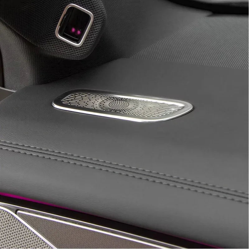 Close-up of a grey leather car interior accessory with a decorative silver metal insert.