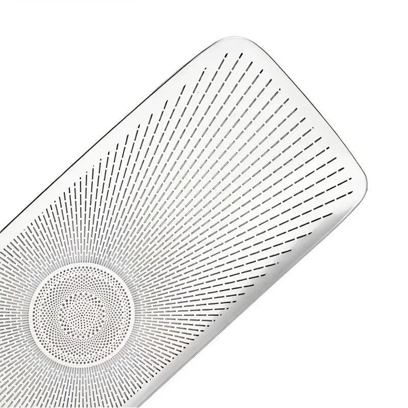 Close-up of a polished chrome silver metal speaker grille with a radial perforated pattern.