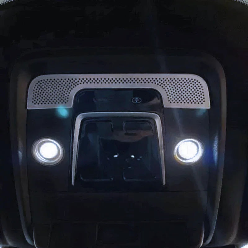 Black interior roof console with silver perforated trim and dual white LED reading lights.