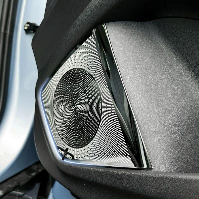 Premium black textured speaker grille with metallic silver trim for car interior audio upgrade.