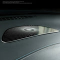 Polished chrome decorative trim with a unique swirling dot pattern for luxury car interior enhancement.
