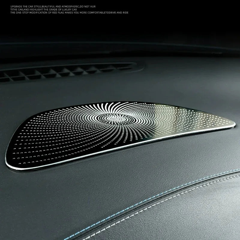 Polished chrome decorative trim with a unique swirling dot pattern for luxury car interior enhancement.