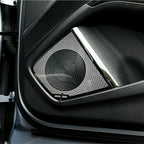 Premium black metal speaker grille with a sleek chrome trim installed on a car door panel.