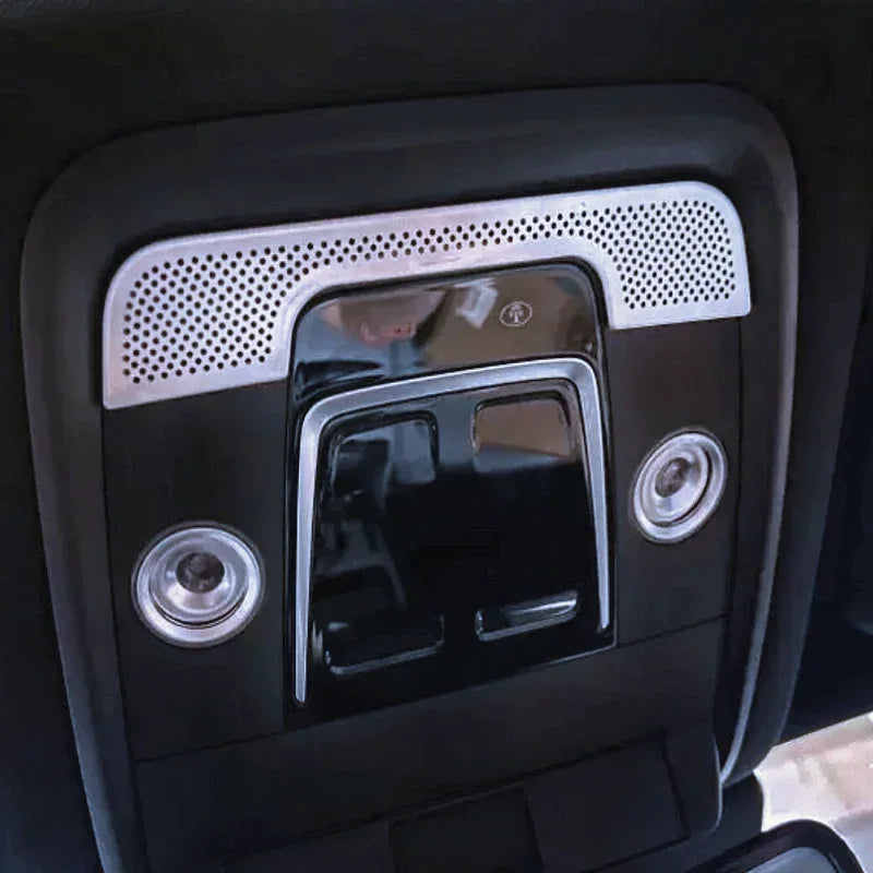 Black gloss interior car ceiling console with silver perforated trim and dual LED spotlights