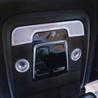 Black gloss interior car ceiling console with silver perforated trim and dual LED spotlights