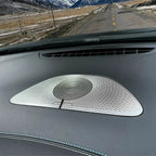 Silver metallic mesh tweeter speaker installed on a dark grey car dashboard.