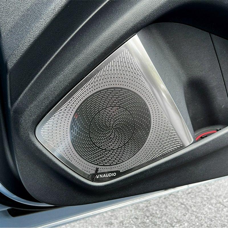 Silver metallic VNAUDIO car door speaker grille with a textured black circular pattern.