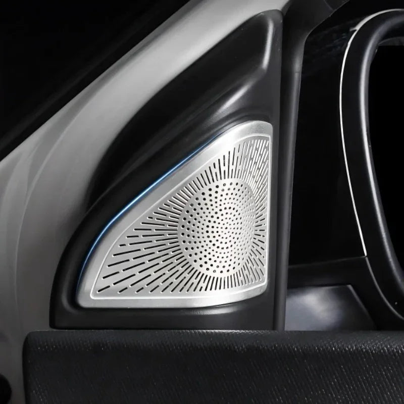 Silver metallic perforated speaker grille cover for car interior door panel