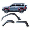 Matte black textured wheel arch fender flares for SUV protection and rugged styling.